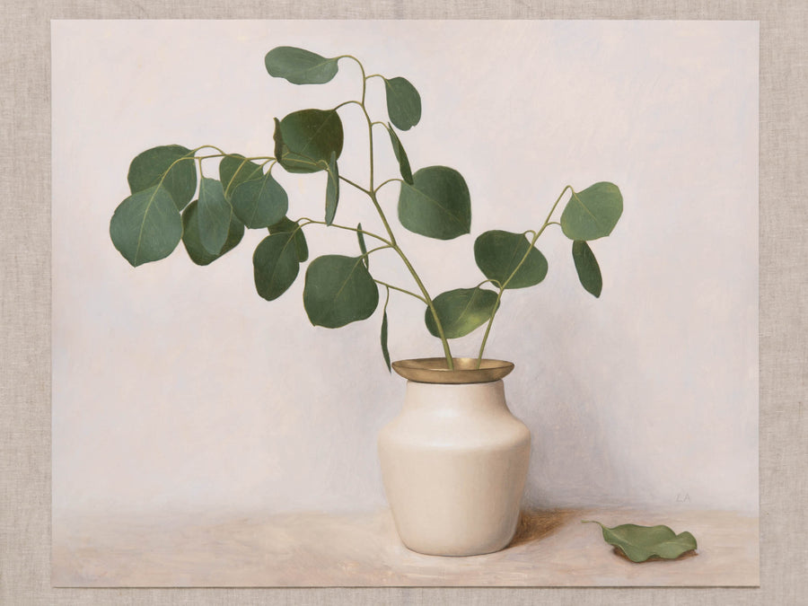 Fine art print of a still life painting of Eucalyptus in a white vase with gold detail and a light background.