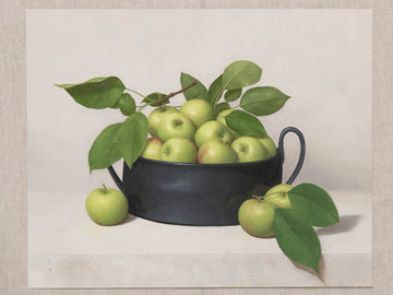Fine art print of a still life painting of a black bowl of green apples with a light background.